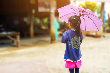 The girl with umbrella and looking at something at home.