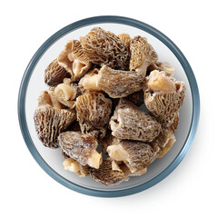 Frozen morel mushrooms in a glass plate on a white background. Isolated frozen mushrooms. Top view. 