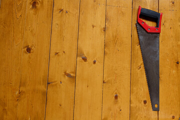 Saw over wooden surface