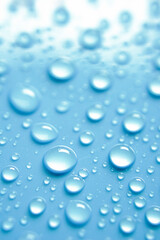Beautiful big alcohol droplets on the light blue background. 