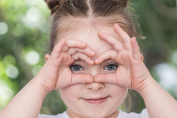 Adorable little girl taken closeup outdoors in summer. High quality photo