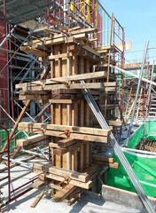 Fototapeta na wymiar MALACCA, MALAYSIA -SEPTEMBER 19, 2016: Column timber formwork and reinforcement bar at the construction site in Malacca, Malaysia. The structure supported by temporary wood support