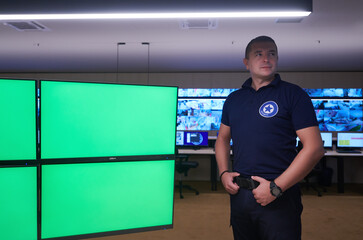 portrait of young male security operator in a data system control room