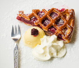 Fruit tart with ball of vanilla ice cream