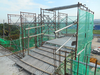 MALACCA, MALAYSIA -SEPTEMBER 23, 2016: Temporary access and staircase supported by reinforced scaffolding at the construction site. Used by construction workers.  