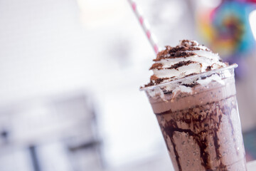 Summer refreshment drinks. Chilled iced chocolate cocoa. Chocolate powder and ice with tubes for drinking in the cafe.