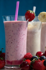 strawberry smoothie milkshake with fresh berries closeup