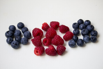 blueberries and raspberries on white background