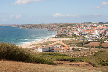 Fototapeta na wymiar view down to the beach and town Praia da Areia Branca, near Lourinha on the Portuguese Silver Coast 