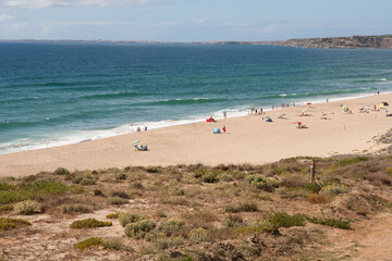 view down to the beach and town Praia da Areia Branca,  near Lourinha on the Portuguese Silver Coast 