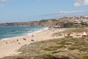 view down to the beach and town Praia da Areia Branca,  near Lourinha on the Portuguese Silver Coast 