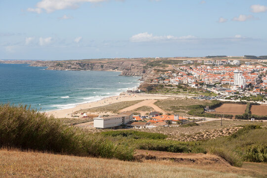 view down to the beach and town Praia da Areia Branca,  near Lourinha on the Portuguese Silver Coast 