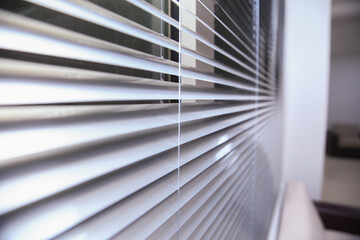 Office blinds. Modern wooden jalousie. Office meeting room lighting range control. venetian blinds by the window . Sunlight coming through venetian blinds by the window .