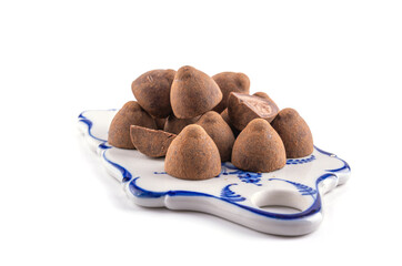 chocolate truffles on a ceramic tray, white isolated background