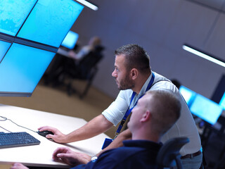 male operators working in a security data system control room