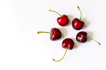 The layout of five ripe red cherries with copy space