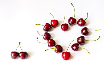 Fototapeta na wymiar Heart-shaped layout of sweet cherry berries