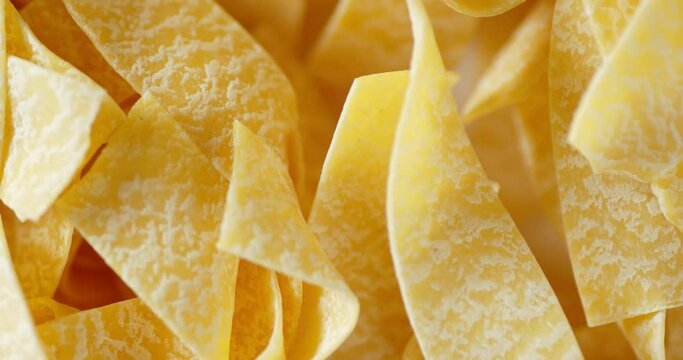 Homemade pappardelle pasta dry slowly rotates.