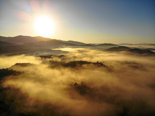 Fototapeta na wymiar Aerial view of foggy sunrise in Donji Kosinj, Croatia