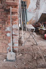 on building site there is a shovel on a brick wall