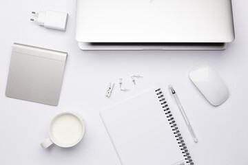 Empty white notebook with pen, working place with keyboard.