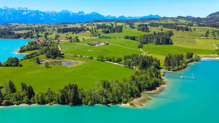 Fototapeta na wymiar Aerial view over Lake Forggensee at the city of Fuessen in Bavaria Germany