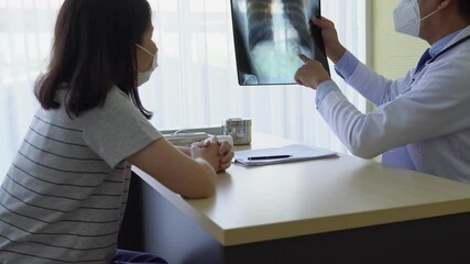 doctor showing chest film to the asian patient who is sick and visits at clinic in hospital. healthcare and medical concept - Powered by Adobe