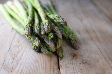 Organic green asparagus on a rustic wooden table, copy space, selected focus, narrow depth of field