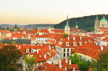 Sunset in old Prague. Red roofs and parks