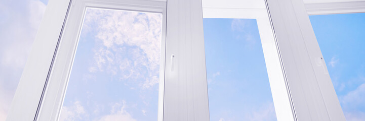Large white plastic window with blue sky panoramic