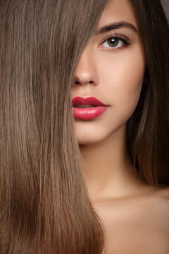 Woman Fashion Portrait. Long Straight Hair Covers Part Of Her Face.