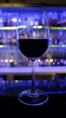 A glass of red wine placed on the counter bar