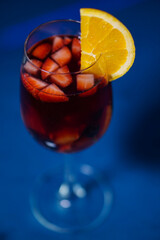 single Sangria wine in the wine glass with slice of strawberry and orange
