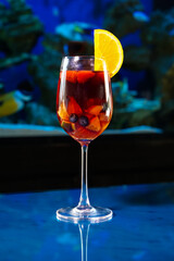 single Sangria wine in the wine glass with slice of strawberry and orange