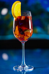 single Sangria wine in the wine glass with slice of strawberry and orange