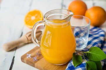 fresh orange juice in a jug, white background