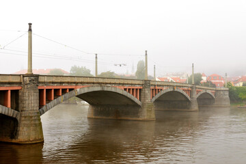 Fototapeta na wymiar Manes Bridge in fog, Prague, Czech Republic