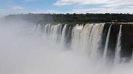 photograph of the famous, grandiose and mighty Iguazu Falls, which give off magical water vapor,...