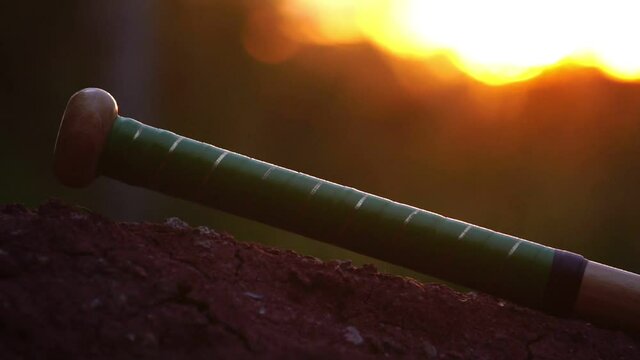 Footage Slow Motion: A baseball player's hand is picking up a baseball bat for training