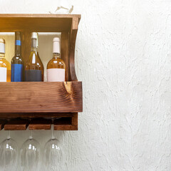 Wooden shelf hangs on white wall for evening celebration. Concept of lifestyle relax, copy space.