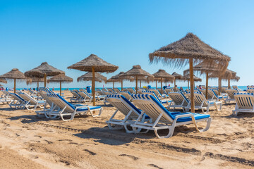 Sunbeds and umbrellas on a beach in Valencia, Spain