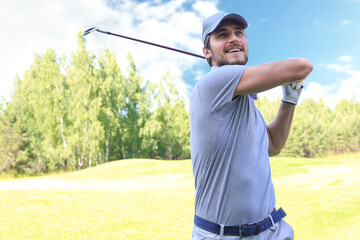 Golfer hits an fairway shot towards the club house.