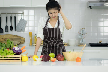 Asian young woman Cooking in the kitchen.With stress