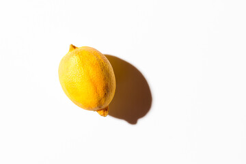 Fresh juicy orange on a white background with a hard shadow. Top view