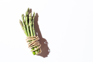 Green fresh asparagus on a gray background