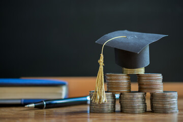 hat graduation model on money coins saving for concept investment education and scholarship