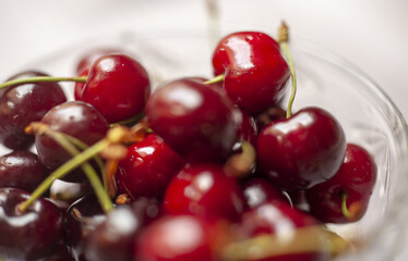 Fresh sweet cherry fruits in a glass bowl