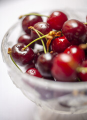 Fresh sweet cherry fruits in a glass bowl