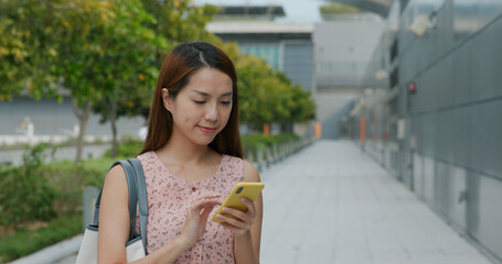 Woman uses mobile phone outdoors