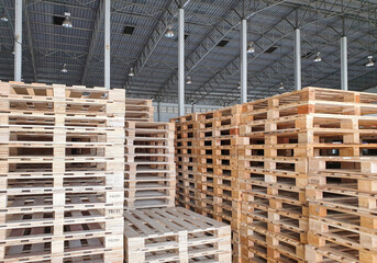 Wooden pallets stacked in stock at warehouse storage.